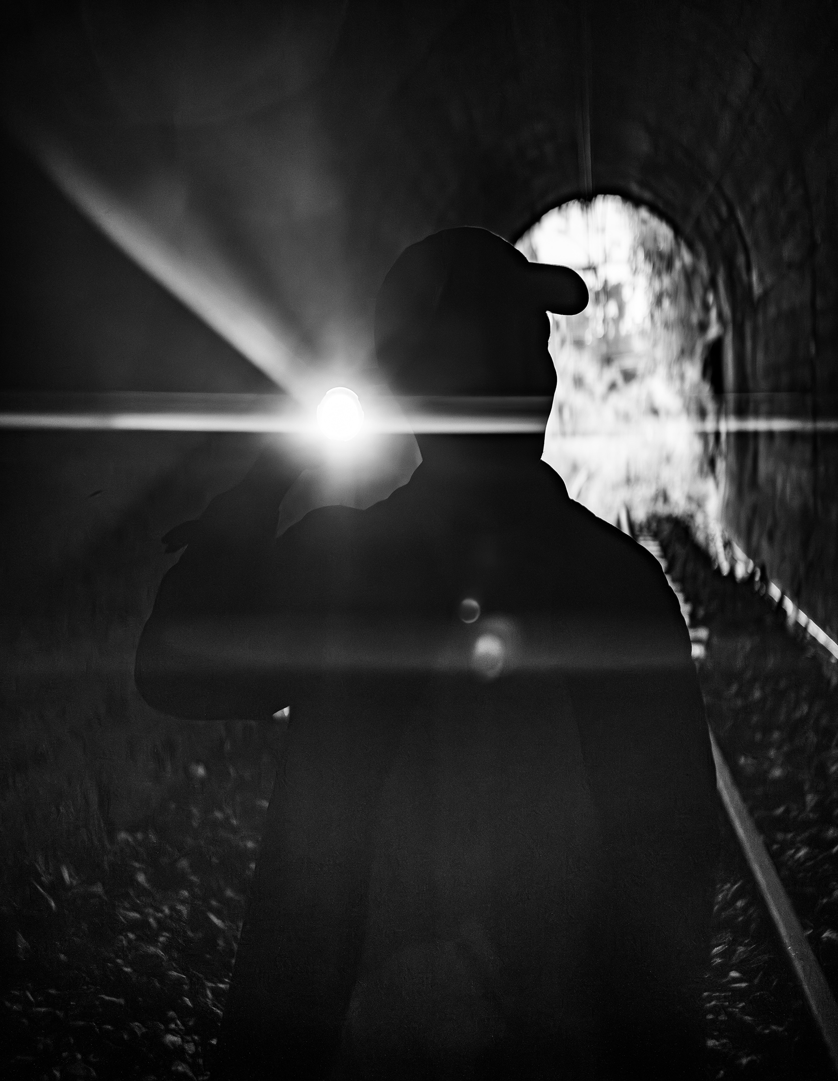 Figure walking through a tunnel toward the light